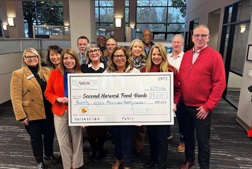 West Coast Community Bank team members presenting a donation check to Second Harvest Food Bank