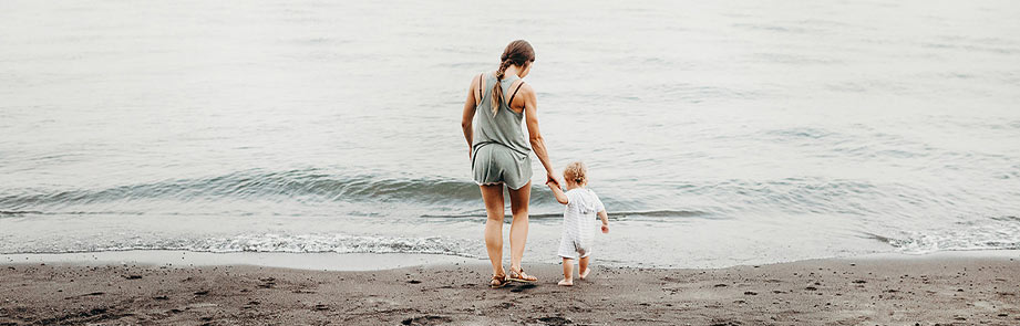Woman and child at the shoreline.
